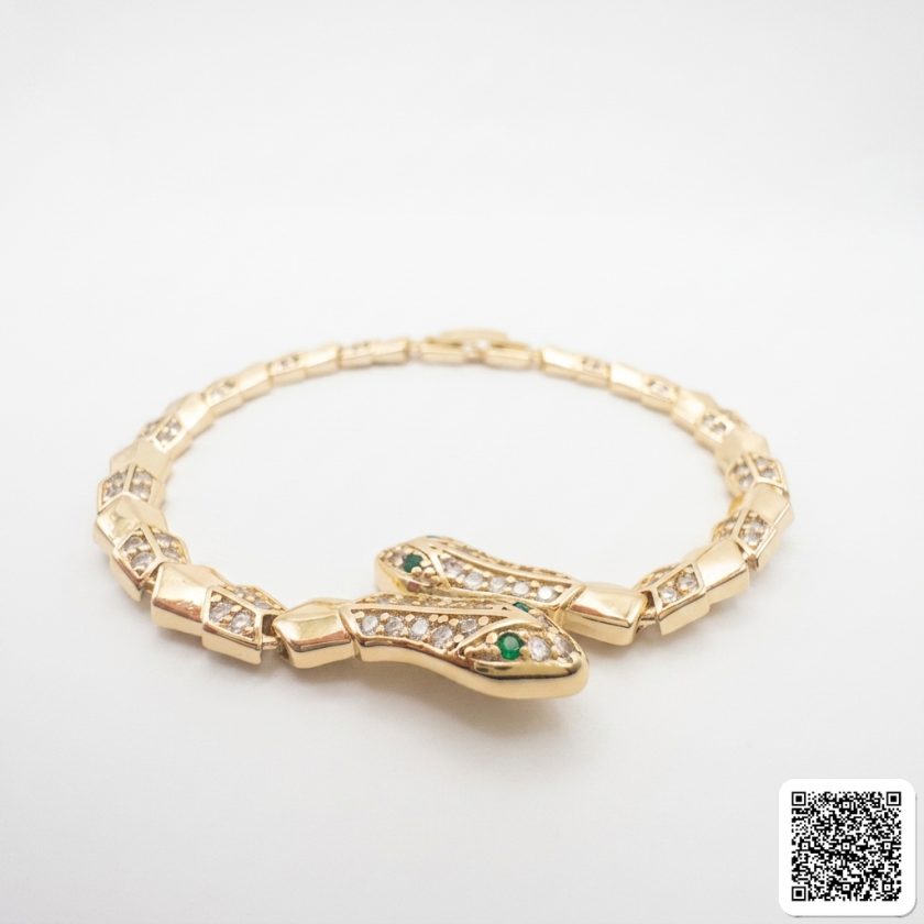 Elegantes Goldfarbenes Armband Mit Strass Und Grünem Stein
